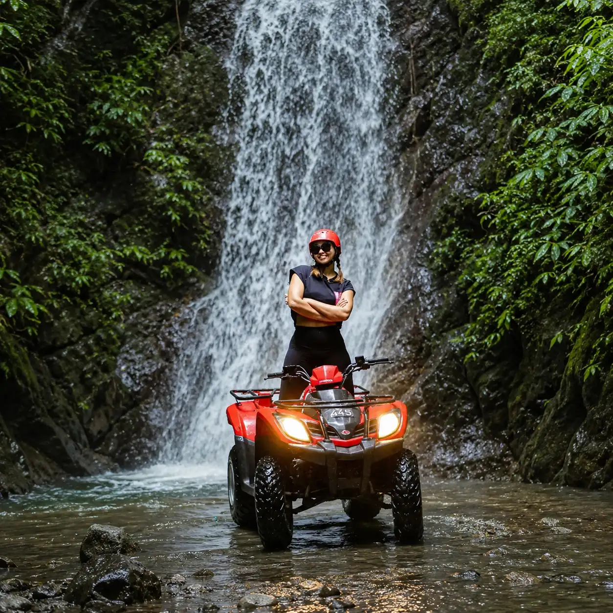 Rider on a Kuber ATV in front of a waterfall near Ubud, Bali